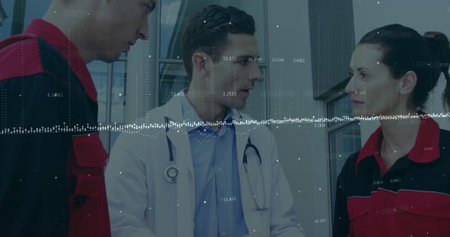 Discussing doctor sharing vital data with EMTs in hallway with glass panels, stethoscope, uniforms. Healthcare, emergency response, collaboration, medical team, clinical environment, data analysis, professionalの写真素材