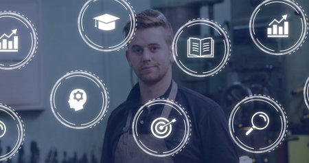 Male technician analyzing education data wearing apron in workshop, with floating analytics icons. Industrial, craftsmanship, training, skill development, manufacturing, workshop, technicalの写真素材