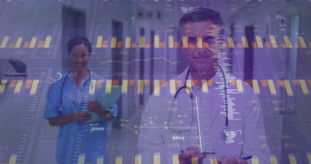 Doctor in white coat analyzing digital data in hospital corridor, with nurse holding clipboard....