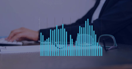 Typing woman in suit jacket analyzing data in office, with keyboard, document and digital bar chart....
