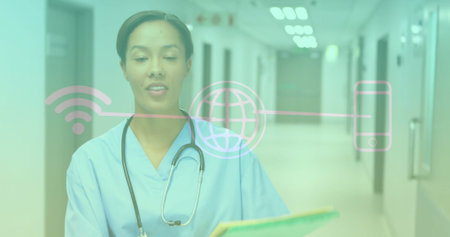Standing nurse in scrubs, holding folder with stethoscope in hospital corridor, with digital icons. Healthcare, telemedicine, medicaltechnology, professional, clinical, connectivity, innovationの写真素材
