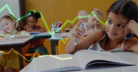 South Asian girl writing in notebook at school, with colored markers, marker cups, copy space. Children, education, classroom, stationery, learning, youthful, academicの写真素材
