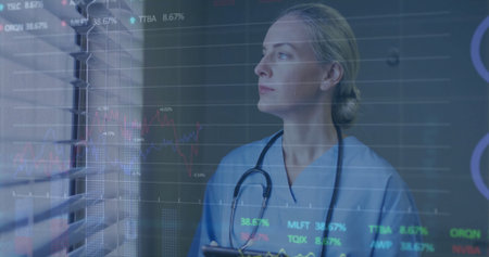 Holding tablet, nurse wearing scrubs and stethoscope at window blinds with data overlay, copy space....