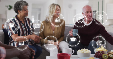 Talking friends sharing snacks on sofa in living room, with coffee table and digital icons....