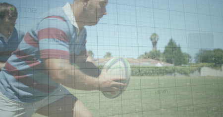 Charging rugby player in striped jersey gripping rugby ball and driving forward on suburban field. Athletics, teamwork, competitive, sporty, activewear, outdoor, vitalityの写真素材