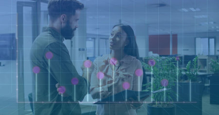 Two colleagues in shirt and blouse discussing data in office, with tablet and stylus, graph overlay. Business, teamwork, innovation, collaboration, technology, workspace, corporateの写真素材