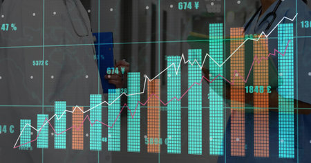 Medical staff in uniform reviewing financial chart in hospital hall, with clipboard, stethoscopes. Professional, finance, analytics, clinical, technology, teamwork, modernの写真素材