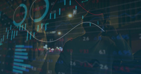 Holding smartphone, commuter standing on street at night, with wristwatch and charts overlay. Urban, technology, financial, nightlife, analysis, professional, data visualizationの写真素材