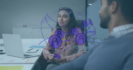 Two coworkers discussing digital network hologram in office meeting room, with laptop and notebook. Collaboration, innovation, technology, business, communication, futuristic, professionalの写真素材