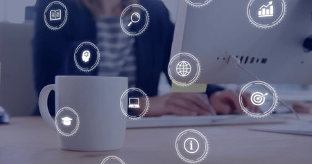 Showing white mug sitting on office desk, businesswoman typing on keyboard with digital icons. Workspace, technology, innovation, corporate, professional, modern, productivityの写真素材