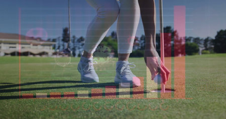 Bending golfer in athletic pants placing golf ball into hole on putting green, with data overlays. Sports, recreation, outdoors, precision, analysis, fitness, leisureの写真素材