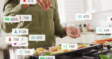 Sprinkling home cook seasoning over veggies on grill pan in home kitchen. Cooking, culinary arts, home cuisine, vibrant, modern, flavor, lifestyleの写真素材