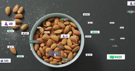 Displaying ceramic bowl holding shelled almonds on gray tabletop showing floating reaction icons. Snack, charisma, minimalist, digital, engagement, organic, modernの写真素材
