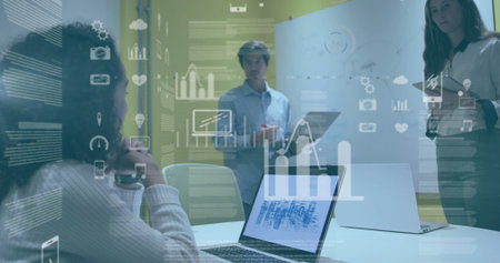 Leading man holding marker guiding colleagues at conference table, with laptops and charts. Collaboration, teamwork, innovation, digital, business, workspace, presentationの写真素材