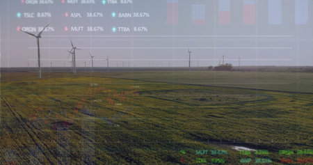 Showing wind turbines spinning over green farmland, with semi-transparent stock ticker overlay....