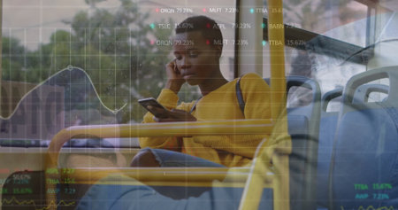 Riding woman in yellow sweater, jeans using smartphone listening on earphones on bus, data overlay. Commuter, transportation, urban, technology, data, commuterwearの写真素材