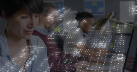 Concentrating Asian woman typing code at desk in tech office, with code overlay, copy space. Technology, innovation, collaboration, workspace, digital, modern, productivityの写真素材