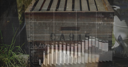 Projecting bar charts and line graphs from wooden beehive box in garden, with metal pail. Nature,...