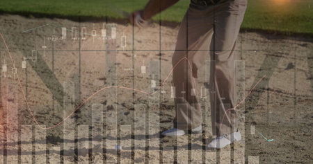 Swinging golfer wearing golf attire in sand bunker on golf course, with golf club and ball. Athletic, leisure, outdoor, sport, precision, competitive, natureの写真素材