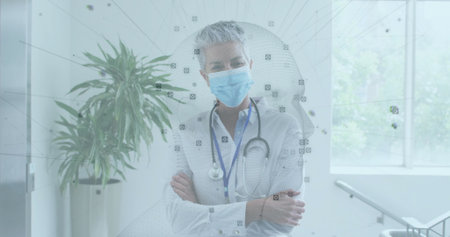 Standing doctor wearing surgical mask and button-up shirt, crossing arms in clinic with stethoscope. Healthcare, professionalism, medical, hospital, consultation, clinical, diagnosticsの写真素材