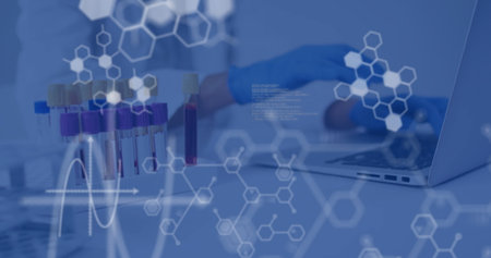 Technician in white coat blue gloves handling blood vials in lab, with laptop molecular graphics. Medical, biotechnology, scientific, analytical, innovative, modern, researchの写真素材