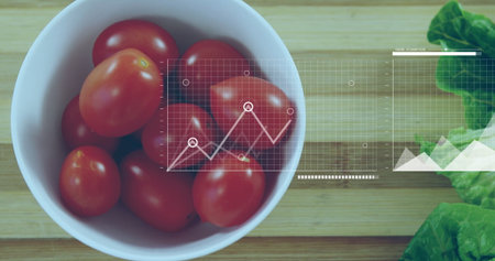 Displaying bowl of cherry tomatoes and lettuce on board in kitchen, graph overlay, copy space. Fresh produce, healthy eating, nutrition, organic, food preparation, minimalist, vibrantの写真素材