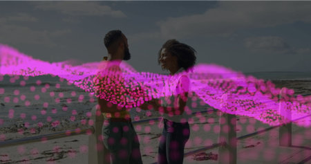 Workout partners lifting green dumbbells on beach boardwalk with pink digital wave overlay. Fitness, wellness, exercise, outdoor, active, vitality, motivationの写真素材