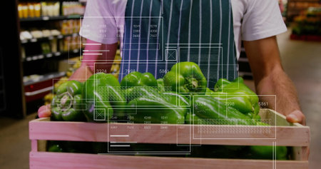 Store clerk wearing striped apron handling green bell peppers at produce aisle, with wooden crate. Fresh produce, retail, market, clean, organized, healthy, vibrantの写真素材