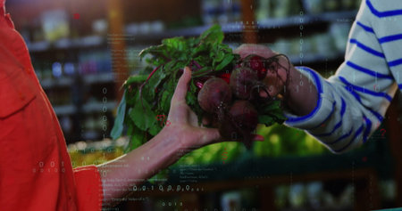 Passing clerk wearing red shirt handing fresh beetroots inside grocery aisle, leafy greens. Produce, retail, wellness, organic, market, healthy, freshの写真素材