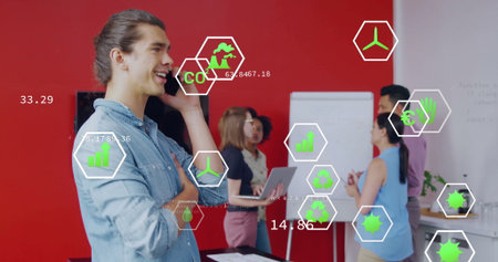 Smiling male professional holding smartphone in meeting room, with laptops flip chart overlays. Collaboration, teamwork, innovation, modern, technology, consulting, businessの写真素材