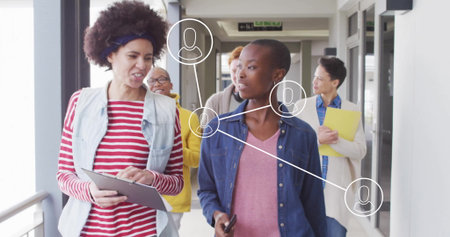 Walking team collaborating on project at office corridor, with tablet smartphone folder icons. Collaboration, teamwork, communication, connectivity, professional, modern, corporateの写真素材