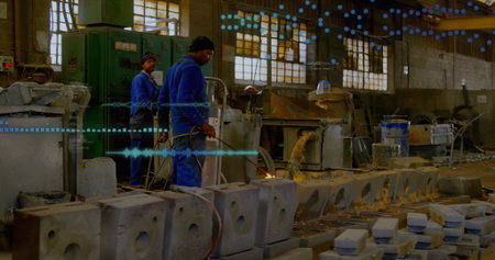 Operating gas torch worker in coveralls heating concrete molds in shop, with control panel....