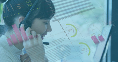 Speaking Asian agent wearing white collared top at office desk, with headset and data overlays....