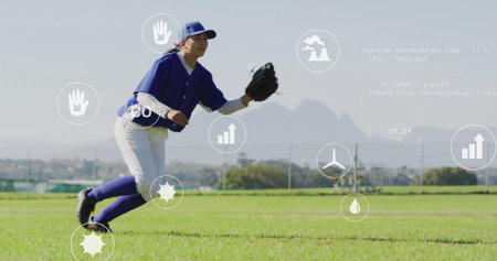 Fielding baseball player wearing blue jersey catching ball in outfield, with glove and data icons. Athletics, sport, teamwork, outdoor, fitness, competition, dynamicの写真素材
