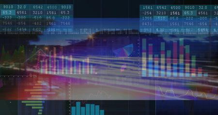 Displaying overlay showing tables charts and graphs over night city skyline with light trails....