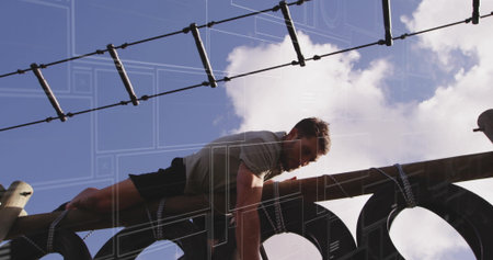 Climbing man in athletic shirt and shorts crossing obstacle course wooden beam and rope ladder....