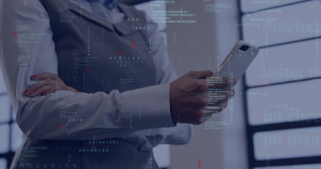 Holding smartphone professional woman in vest and shirt viewing code projections at modern office. Technology, innovation, corporate, digital, futuristic, data, analyticsの写真素材