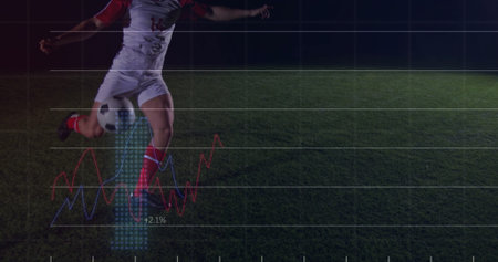 Kicking uniformed soccer player striking ball on pitch at night, with grid overlay, copy space. Athletic, sport, motion, competition, energetic, outdoor, dynamicの写真素材