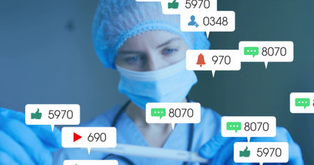 Holding pipette female health worker in scrubs transferring liquid in lab.の写真素材