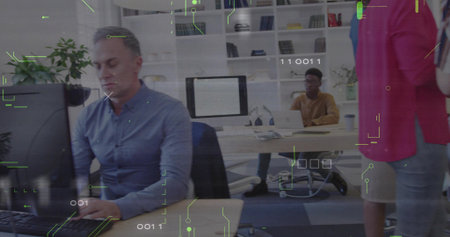 Focusing mature man wearing shirt working at office desk, with dual monitors and plant, copy space....