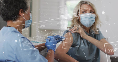 Injecting nurse in scrubs and gloves giving vaccine into arm in clinic with syringe, data panels....