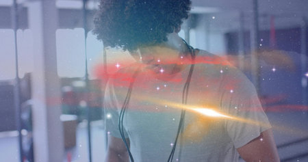 Healthcare worker in white tee fastening stethoscope in hospital corridor, with overhead lighting. Medic, clinical, professional, modern, clean, wellness, diagnosisの写真素材