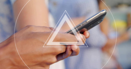 Tapping smartphone screen by man in white shirt at gathering, with yellow mug, blue patterned dress. Minimalist, contemporary, casual, wellness, social, lifestyle, connectionの写真素材