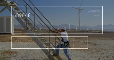 Climbing white male technician ascending metal staircase at wind farm turbine, viewing AR overlay....