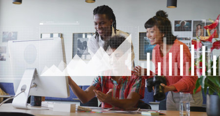 Three colleagues collaborating around computer monitor in office, with DSLR camera and notebooks. Collaboration, teamwork, modernoffice, digitalgraphics, creativeworkspace, innovation, startupの写真素材