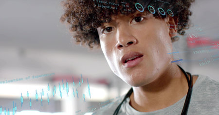 Doctor sweating; studying financial digital policy charts in hospital corridor, with stethoscope. Medical, corporate, modern, healthcare, professional, analytical, clinicalの写真素材