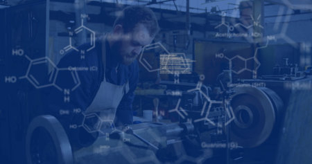 Operating machinist in shirt and apron turning metal lathe in workshop. Industrial, craftsmanship, precision, engineering, innovation, teamwork, technicalの写真素材