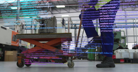 Technician in blue coverall pushing loaded scissor lift with block across workshop, code overlay....