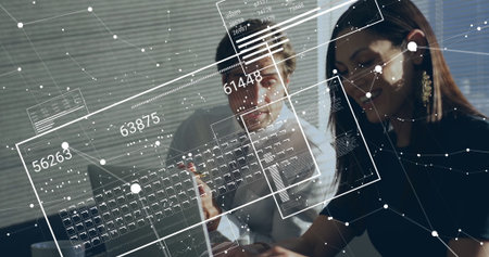 Two office professionals reviewing laptop screen with pen in office, with floating data panels. Collaboration, analytics, digital, innovation, teamwork, modern, professionalの写真素材