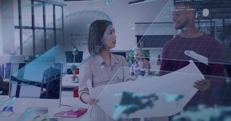 Reviewing two architects examining blueprint in open-plan office, with holographic overlays....